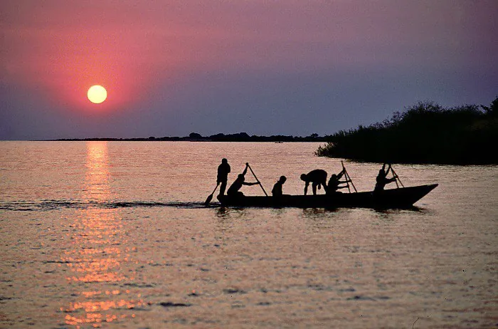 Fishermen on the lake at sunset